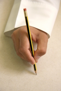 Una mano che scrive con un lapis